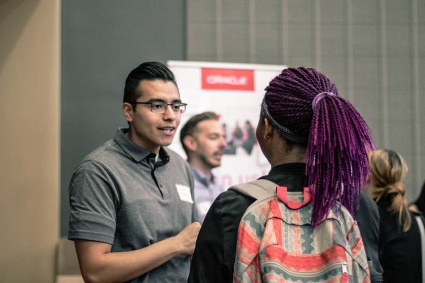recruiter talking to student at career fair