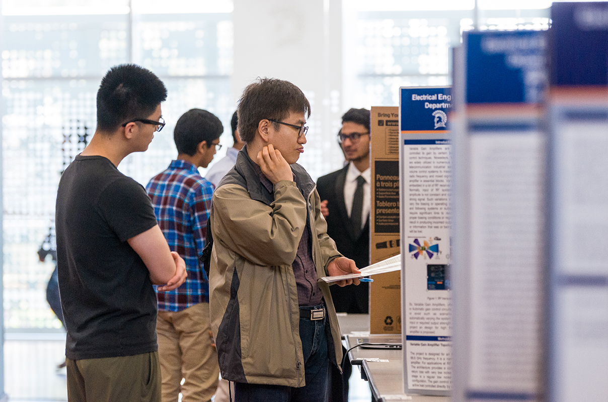 SJSU students at the project expo showing their poster