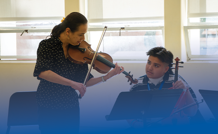 Insturctor teaching a student from be a music major for a day