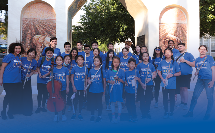 Photograph of many summer camp students in Many summercamp students standing in front of the Arch of Dignity, Equality, and Justice