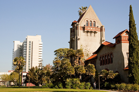 tower hall in foreground of landscape, modern building in back