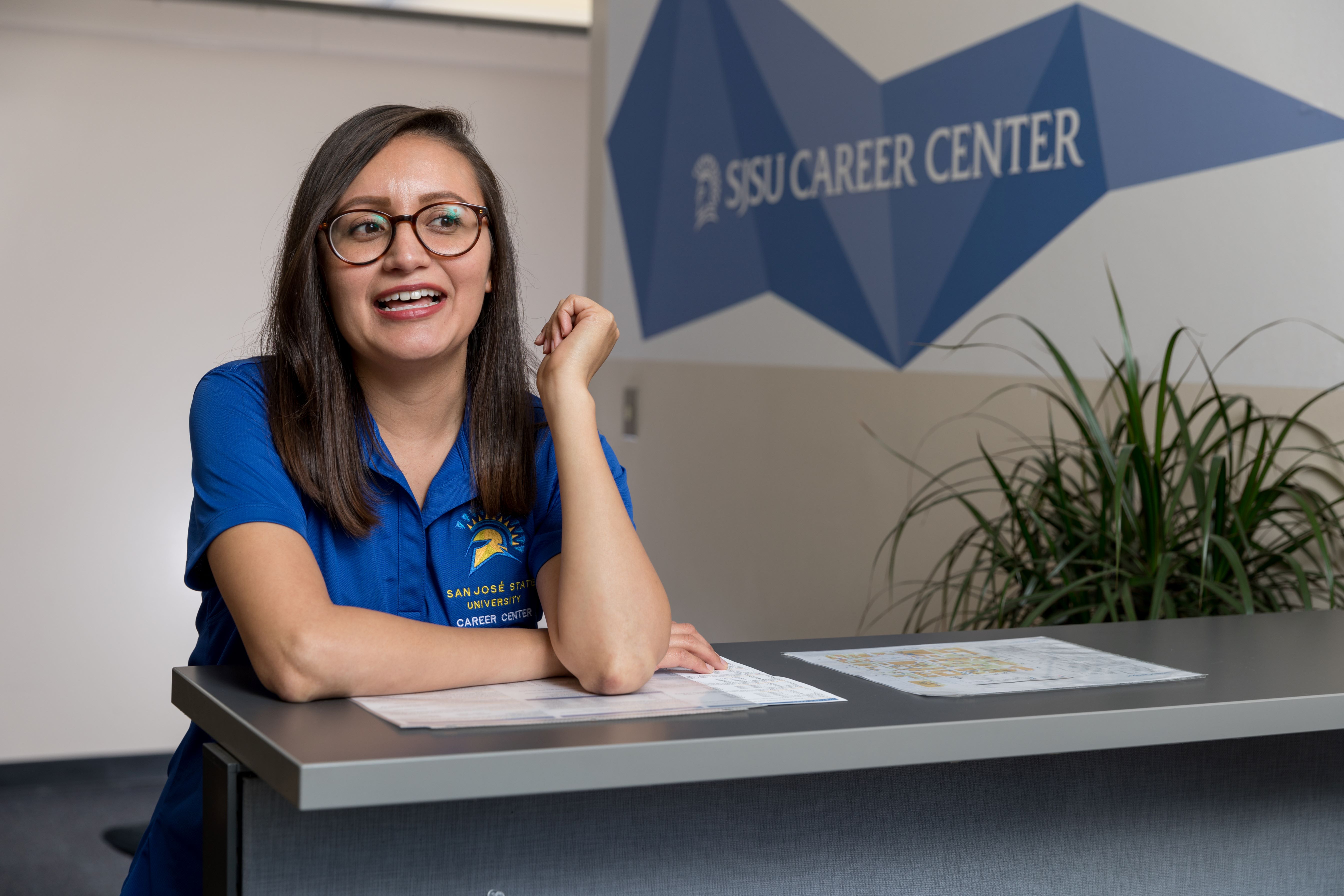 A Career Center employee sits at a desk.