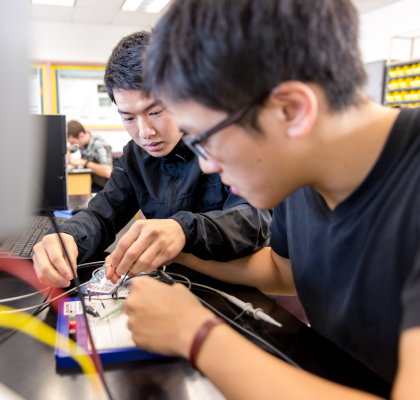 Intellectual Wellness - Two students testing computer