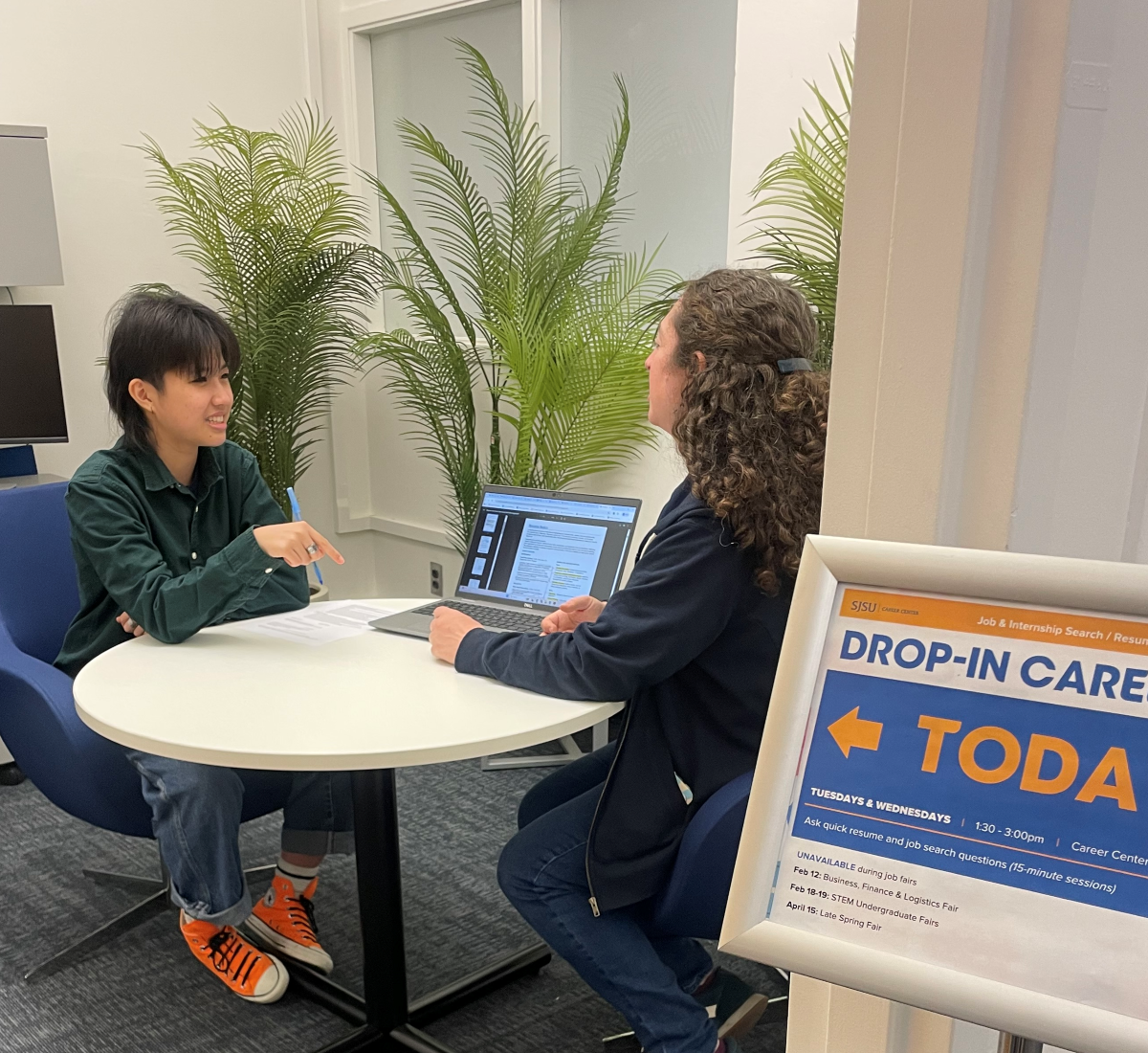 student sitting down with a career counselor
